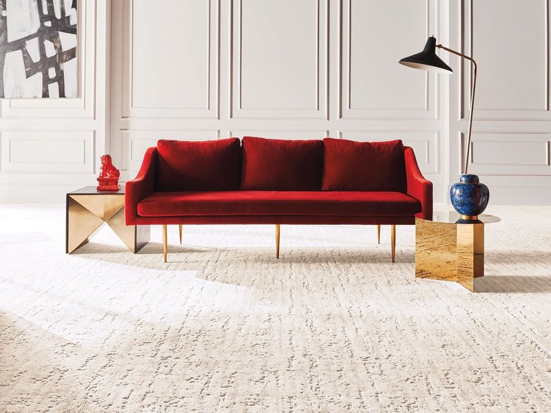 red sofa on carpet - contractorscarpetsource